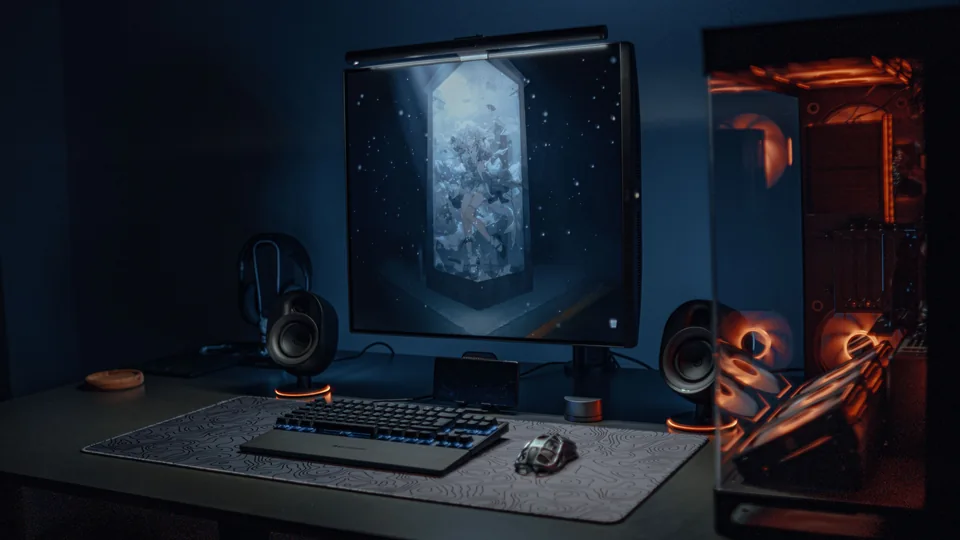 A desktop gaming setup with a monitor, keyboard and PC