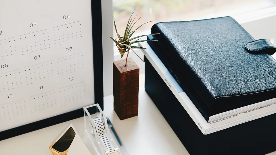 Calendar and notebooks arranged on a planning desk