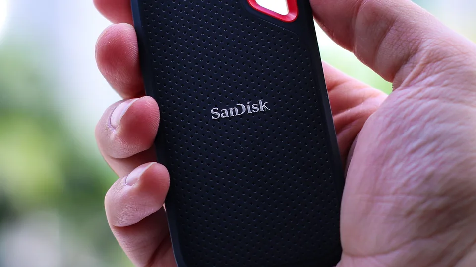 A hand holding a portable external solid state drive