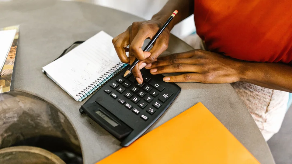 Using a calculator and notebook to plan a budget